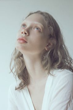 a woman with long hair looking up into the sky