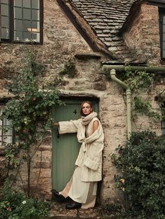 a woman is standing in front of a door