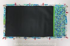 a black board with green and blue squares on it