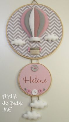 a pink and gray hot air balloon with name on it's wall hanging decoration