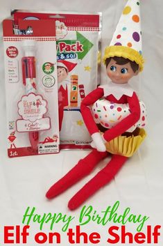 an elf is holding a cupcake in front of the birthday gift bag and it says happy birthday elf on the shelf