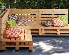 a wooden bench sitting on top of a hard wood floor next to a tree filled forest