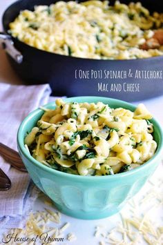 one pot spinach and artichoke macaroni and cheese in a blue bowl