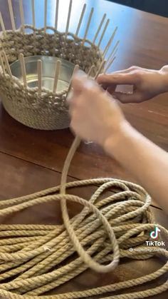 someone is making a basket out of rope