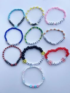 six bracelets with the word smile written on them, all in different colors and sizes