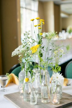 flowers in vases are arranged on a table