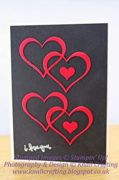 a black card with red hearts on it