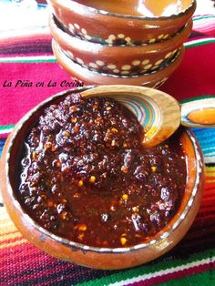 a bowl filled with chili sauce next to another bowl