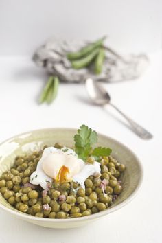 a bowl filled with green beans and an egg