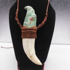 a necklace with a long horn on it