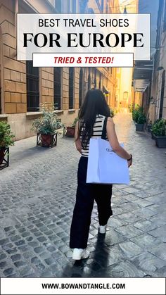 a woman carrying shopping bags in the middle of a cobblestone street with text overlay reading best travel shoes for europe tried