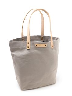 a gray and tan tote bag on a white background