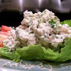 a plate with lettuce and chicken salad on it