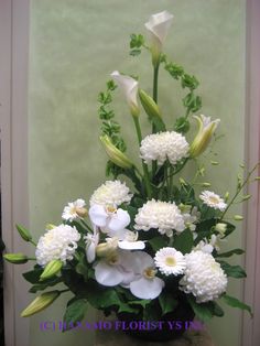 a vase filled with white flowers on top of a table