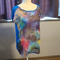 a mannequin is wearing a colorful shirt