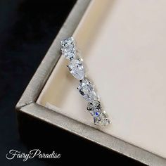 a diamond ring sitting in a box on top of a table