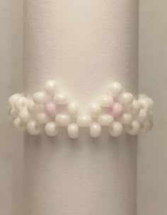 a close up of a white object with beads on it