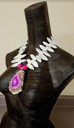 This white, black and hot pink statement necklace is not only lightweight but the perfect proportions for petite women wanting a wearable art statement chest piece! The zebra jasper slab pendant, measuring 4" x 2.5" hosts a gorgeous hot pink variegated agate framed with two rows of rhinestones: one pink and one silver aurora borealis. Two hot pink wood beads and rhinestone rondelles flank the pendant which is suspended from an 20-22" adjustable black and white jasper statement necklace. Finished with silver tone hardware and a lobster claw clasp. Has a 2" extender chain and I can add more links if requested. From the Atelier of Kat Kouture! Luxury Pink Necklace As A Statement Piece, Pink Sterling Silver Necklace With Large Pendant, Unique Pink Necklace With Large Pendant, White Jasper, Unique Jasper Jewelry With Large Pendant, Black And Hot Pink, Pink Agate Pendant Necklace, Pink Statement Necklace, Art Statement