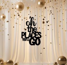 a backdrop with balloons, stars and the words oh the places you'll go