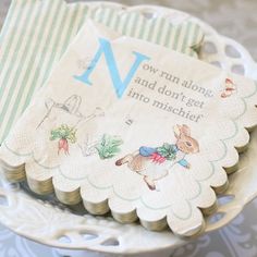 a close up of a cupcake on a plate with a napkin in the shape of a baby's first year