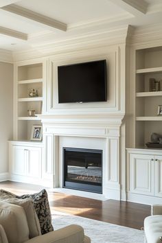 a living room filled with furniture and a flat screen tv mounted on the wall above a fireplace