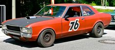 an orange race car with the number seventy painted on it