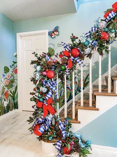 a staircase decorated with christmas decorations and bows