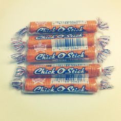 three orange batteries sitting next to each other on a white surface with the words chick o'stick printed on them