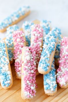 colorful sprinkles are arranged in the shape of letters on a cutting board