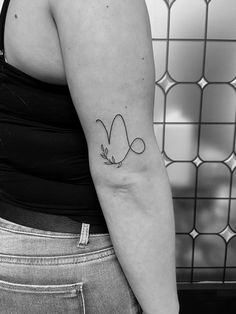 a woman with a small tattoo on her arm