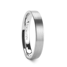 a white gold wedding ring with an inscription engraved on the side and a satin finish