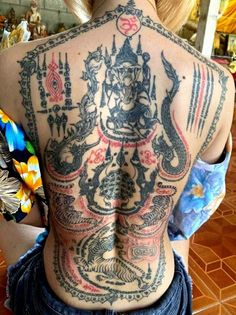 the back of a woman with tattoos on her body