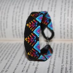 a bracelet is sitting on top of an open book