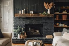 a living room filled with furniture and a fire place in front of a brick fireplace