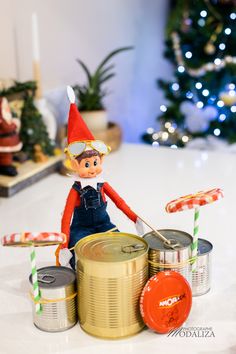 an elf is sitting on top of some tins