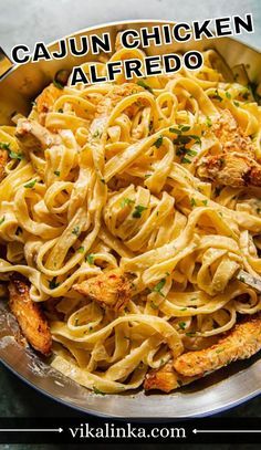 a pan filled with chicken alfredo pasta on top of a table