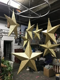 five gold stars hanging from the ceiling in a room filled with other decorations and furniture