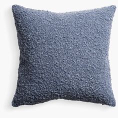 a blue pillow on a white background