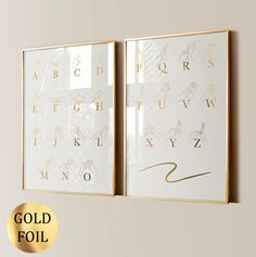 two gold foiled alphabets are hanging on the wall