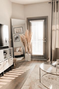 a living room filled with furniture and a flat screen tv