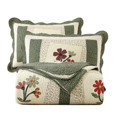 three pillows with flowers on them and one has a quilted cover over the pillow