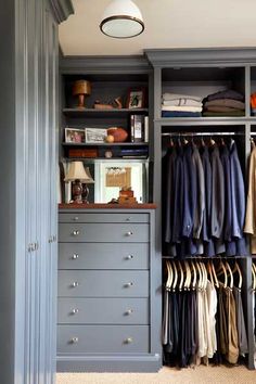 an organized closet with clothes hanging on shelves and drawers, along with other clothing items