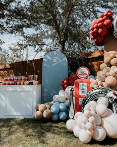 an assortment of balloons and other items on display in front of a fenced area