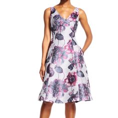 a woman wearing a dress with flowers on it