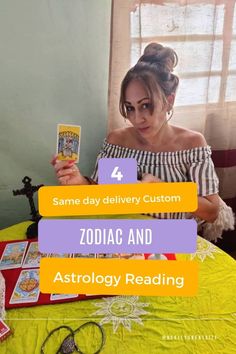 a woman sitting at a table with an astrology book and reading material in front of her