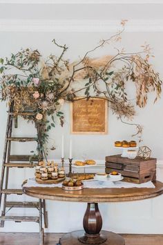 a table topped with donuts next to a ladder