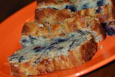 slices of blueberry bread on an orange plate