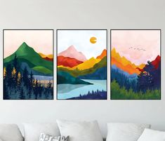 three paintings are hanging on the wall above a couch