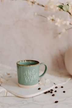 a green coffee cup sitting on top of a white tray