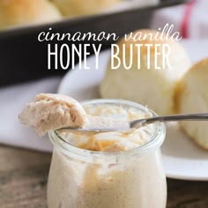 cinnamon vanilla honey butter in a glass jar with a spoon on the side and another plate behind it